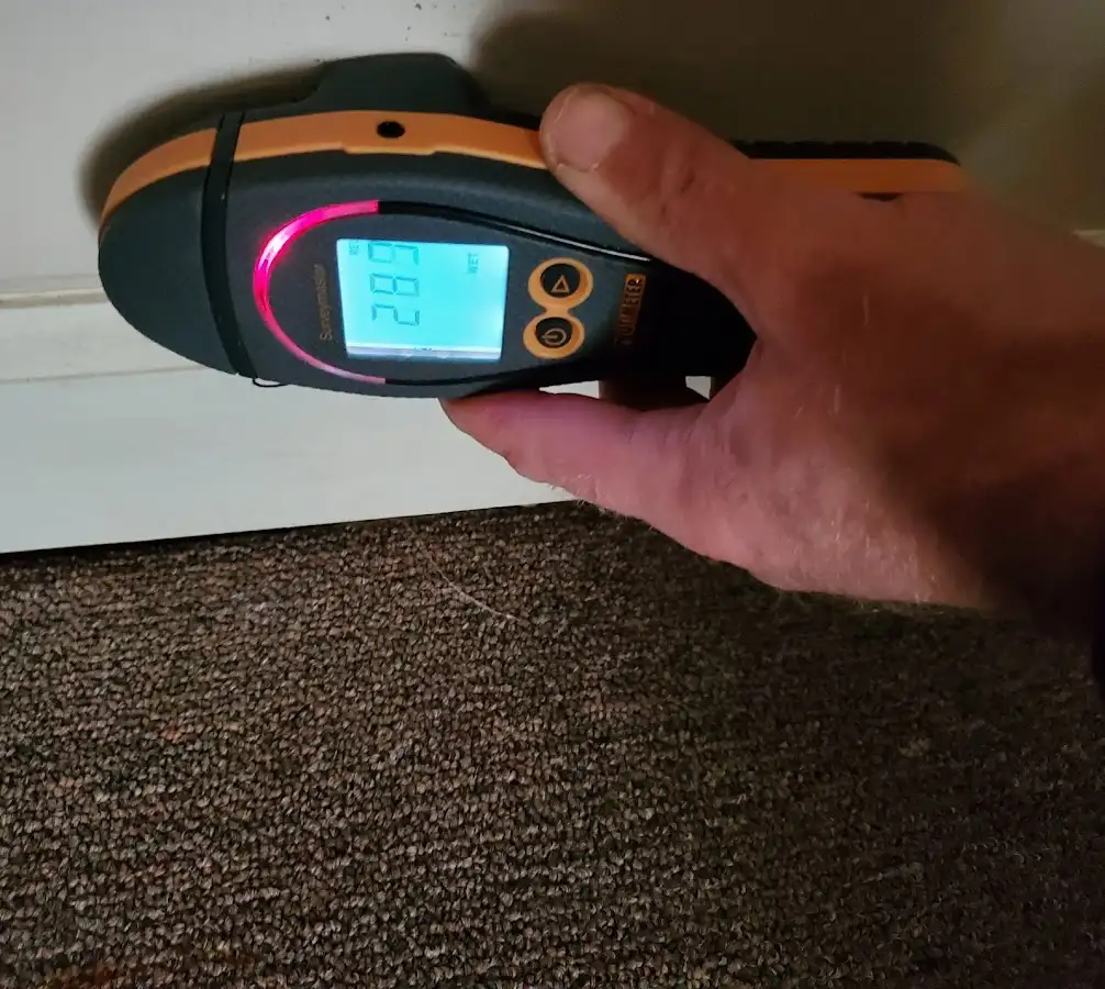 Moisture detection at baseboard during Storm Damage Restoration in McNair